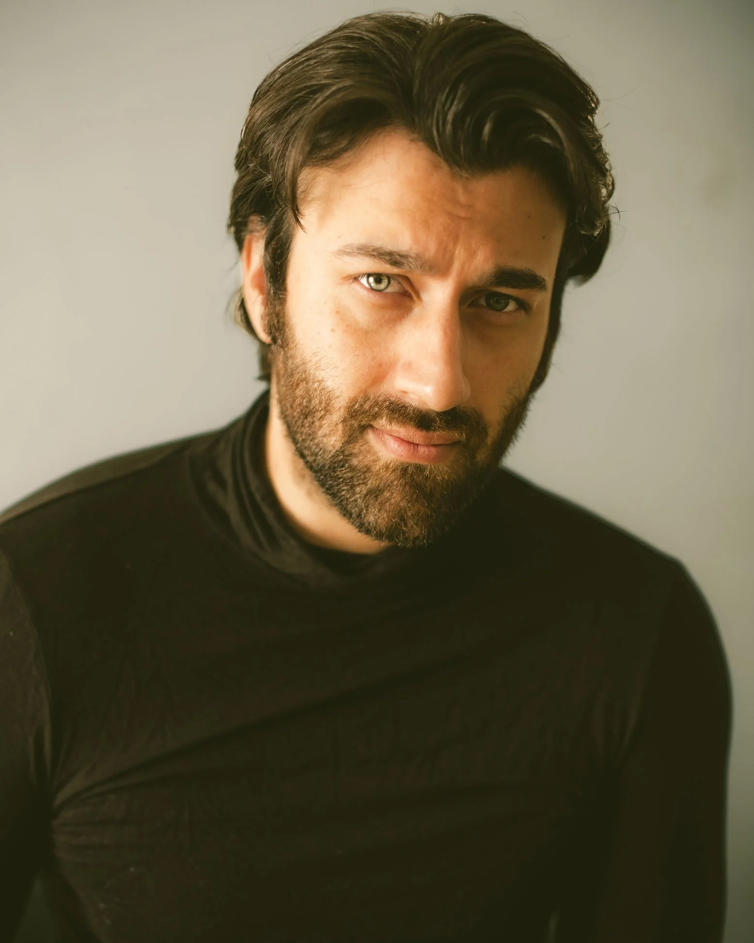 Rohed Khan in a warm studio portrait